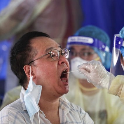 A medical worker takes a swab from a taxi driver at a makeshift Covid-19 testing station in a car park in Hong Kong. Photo: SOPA Images via ZUMA Wire/dpa