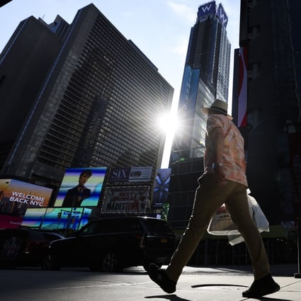 A person walks through a quiet Times Square in New York on August 24. Data shows that the number of new Covid-19 cases reported each day in the US since the beginning of the outbreak has begun to edge lower. Photo: EPA-EFE