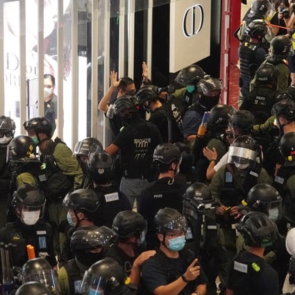Riot police officers arrest an anti-government protester during a demonstration to mark the first anniversary of the Yuen Long attacks, at Yoho Mall on July 21. Photo: Felix Wong