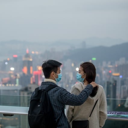 The masks are on as visitors take in the Hong Kong skyline from the Victoria Peak viewing terrace on February 3. The WHO declared Covid-19 a pandemic more than a month later. Photo: Bloomberg