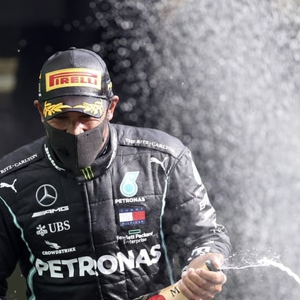 Mercedes driver Lewis Hamilton sprays champagne as he celebrates on the podium after winning the Belgian Grand Prix. Photo: AP
