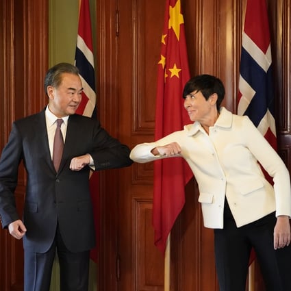 Chinese Foreign Minister Wang Yi greets his Norwegian counterpart Ine Eriksen Soreide with an elbow bump in Oslo on Thursday. Wang is on a five-nation tour of Europe. Photo: Xinhua