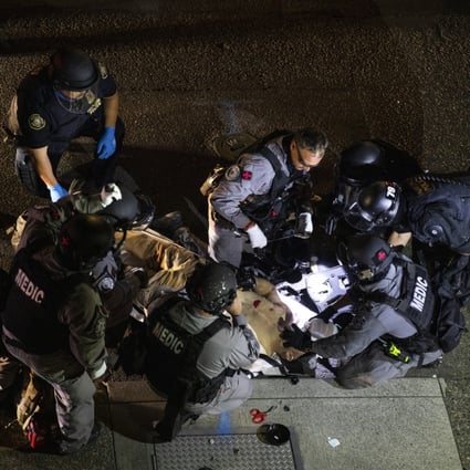 A man is treated after being shot on Saturday in Portland. Photo: AP Photo