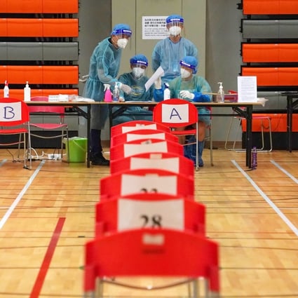 Medical workers at the Harbour Road Sports Centre in Wan Chai, which is being used as a Covid-19 test centre. Photo: Felix Wong