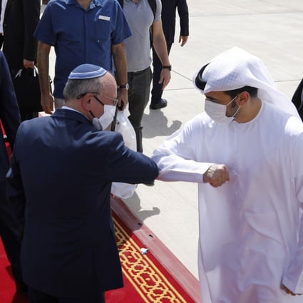 Israeli National Security Advisor Meir Ben-Shabbat elbow bumps with an Emirati official as he makes his way to board the plane to leave Abu Dhabi. Photo: EPA-EFE