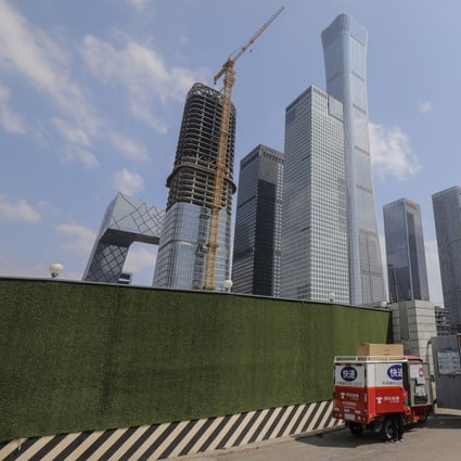 A security guard walks out of from a suspended construction field in the central business district in Beijing in April 2020. Photo: EPA-EFE