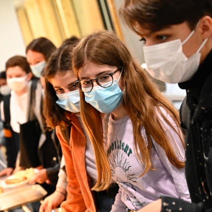 Pupils wearing protective masks queue at the cafeteria in Brequigny high school in Rennes. Photo: AFP