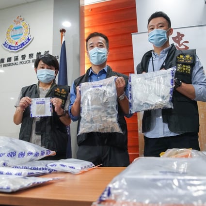 Officers (from left) Lam Yuen-ling, Alan Chung, and Chan Yuen-fun, with some of the evidence seized during the operation in Tsuen Wan. Photo: Winson Wong