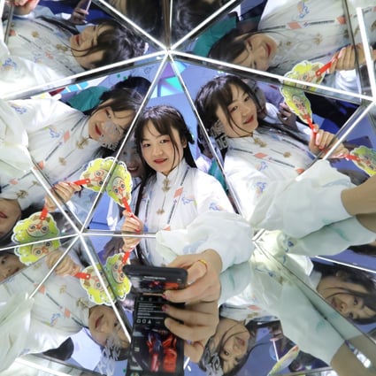 Visitors take selfies at the China International Fair for Trade in Services in May 2019. Photo: Simon Song