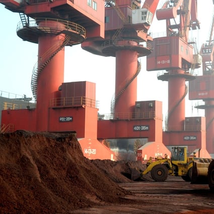 Workers transport soil containing rare earth elements for export at a port in Lianyungang, Jiangsu province, China. Photo: Reuters