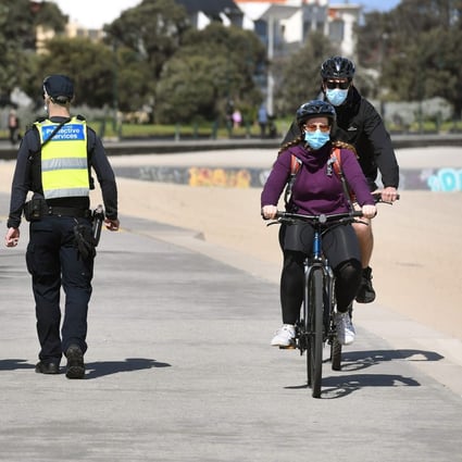 Protective services officers patrol along the St Kilda Beach foreshore in Melbourne as the city battles an outbreak of the coronavirus. Photo: AFP