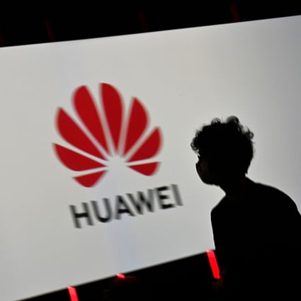 A visitor walks past the logo of Huawei Tehnologies displayed on a screen during the IFA international trade show for consumer electronics and home appliances, held from September 3 to 5 in Berlin. Photo: Agence France-Presse
