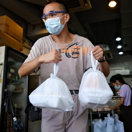 How Covid-19 adds to plastic waste: a man carries takeaway meals packed in single-use boxes carried in single-use plastic bags while wearing a single-use face mask in Hong Kong. Photo: AFP