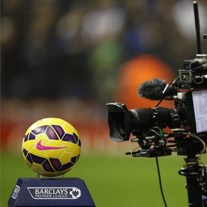 A television cameraman films the match ball before an English Premier League match. Photo: Reuters