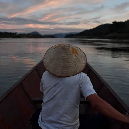 A fisherman on the Mekong River in northeastern Thailand, with Laos on the left. Photo: AFP