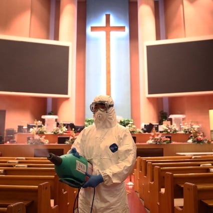 A health worker sprays anti-septic solution in a church in Seoul. Photo: Getty Images/TNS