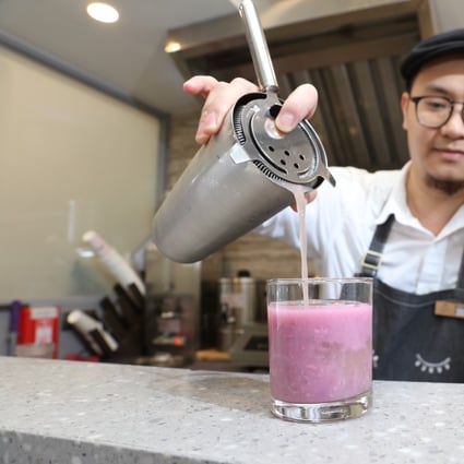 A mixologist prepares a mocktail of purple sweet potato and oats rice water in the Sheung Wan store of CheckCheckCin, which is promoting a modern approach to traditional Chinese medicine among Hong Kong’s younger consumers. Photo: Felix Wong