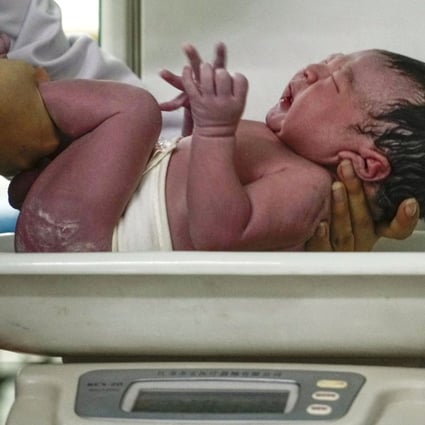 A newborn is weighed at a hospital in China’s Hebei province. Photo: Xinhua