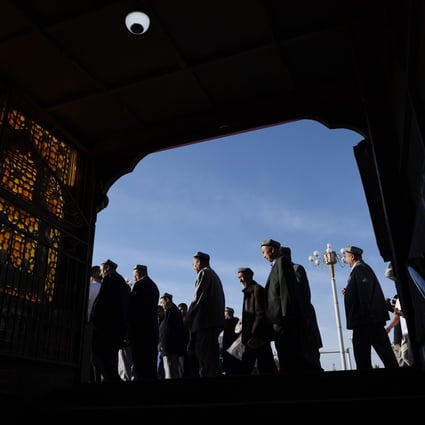 Uygur men make their way past a subway entrance after Eid al-Fitr prayers, marking the end of Ramadan, at the Id Kah mosque in Kashgar, in June last year. Photo: AFP