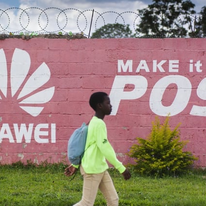 A pedestrian passes the Huawei logo painted on a wall in Lusaka, Zambia, on December 11, 2018. Many digital infrastructure projects in Zambia, like the more visible airport terminals and highways, are being built and financed by China. Photo: Bloomberg