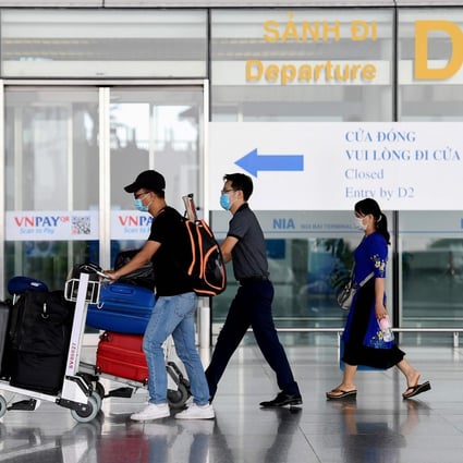 Passengers walk with their luggage at the departure terminal at Noi Bai International Airport in Hanoi on Wednesday. Photo: AFP