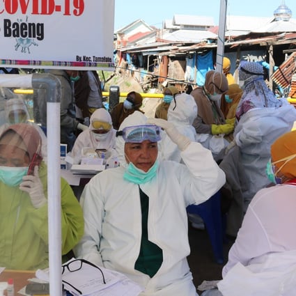 Health workers wear hazmat clothing while working on the front lines against Covid-19 in Indonesia. Patients worried about what neighbours will think have asked health workers to take them to hospital at dead of night. Photo: Shutterstock