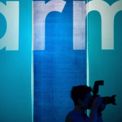 This file photo taken on May 27, 2019 shows a photographer taking pictures in front of the logo for British chip designer ARM in Taipei. Photo: AFP