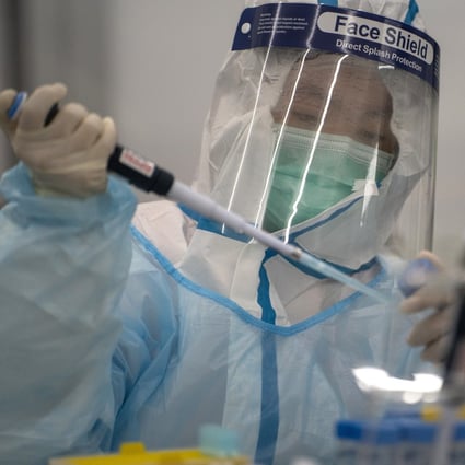A lab technician processes RT-PCR Covid-19 tests at Prenetics’ laboratory in Hong Kong. Photo: Bloomberg