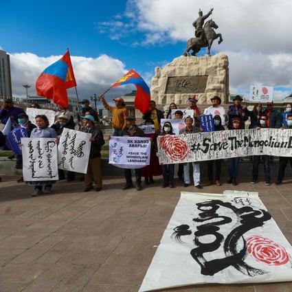 Protesters in Ulan Bator hold a banner reading “save the Mongolian language” during a demonstration last week against China’s decision to expand use of Mandarin instead of Mongolian in Inner Mongolia. Photo: EPA-EFE