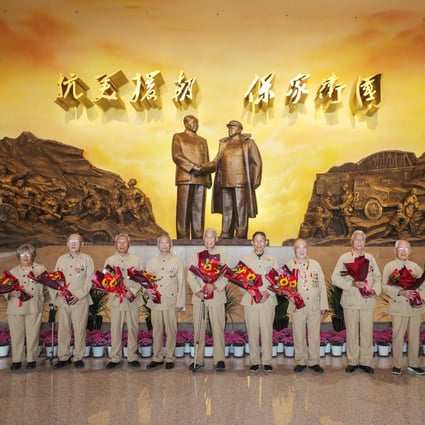 Veterans of the Chinese People's Volunteers (CPV) pose for a group photo at the Memorial Hall of the War to Resist US Aggression and Aid Korea in Dandong on Saturday, when it reopened. Photo: Xinhua