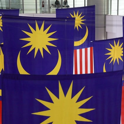 Malaysian national flags are seen inside a shopping centre earlier this month. Photo: EPA