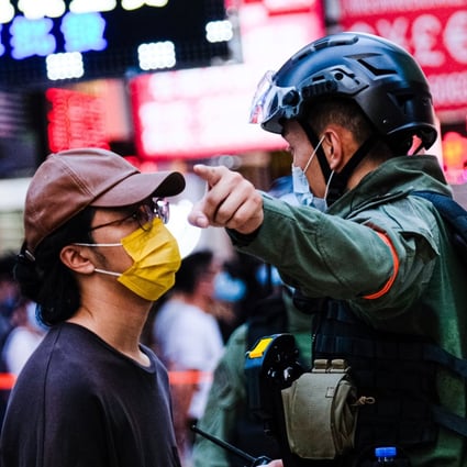 A police officer tells a man to move away during an anti-government protest in Hong Kong on September 6. Photo: dpa