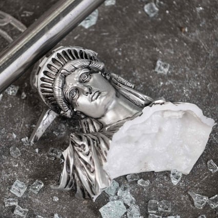 A broken Statue of Liberty figure is seen amid glass shards outside a looted souvenir shop in New York City, after a night of protests on June 2 over the death of George Floyd. Is the world seeing the end of the aura of American exceptionalism that has given the dollar Teflon-like resilience for most of the post-World War II era? Photo: AFP
