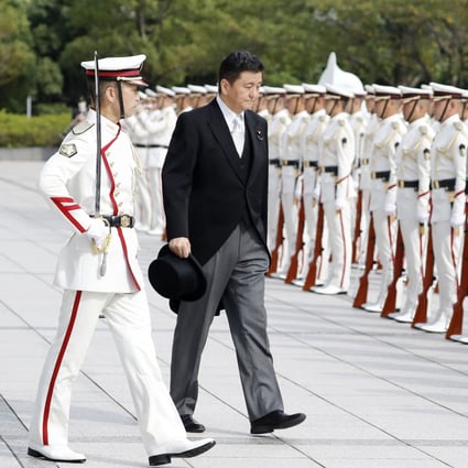 Japan‘s defence minister, Nobuo Kishi, receives a guard of honour during a ceremony in Tokyo a day after he took up the post. Photo: Kyodo