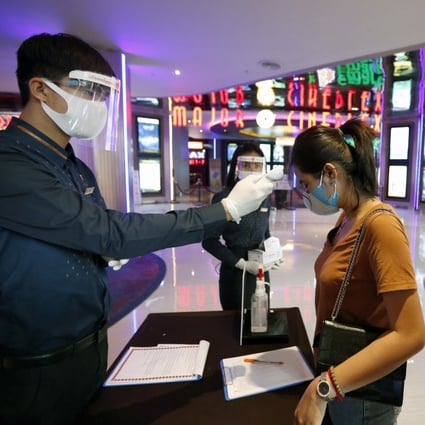 Cinema patrons get their body temperature checked as part of Covid-19 screening. Design changes to entertainment premises are needed in the long run to fight the virus. Photo: EPA-EFE