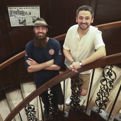 Torbjorn Pedersen (left) and Daniel Herszberg met up at the Foreign Correspondents’ Club in Central, Hong Kong, to share their experiences after both had to abandon attempts on world travel records due to the coronavirus outbreak. Photo: Jonathan Wong
