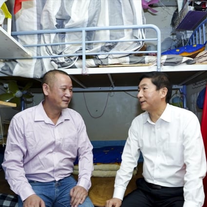 Luo Huining, director of Beijing’s liaison office in Hong Kong, talks with a man in his subdivided Sham Shui Po flat. Photo: Handout