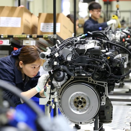 Workers build car engines at a factory in Mianyang, Sichuan province. Photo: Reuters