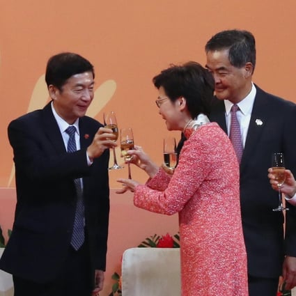 Carrie Lam raises a glass with Luo Huining, director of the central government's liaison office in Hong Kong, as other dignitaries look on. Photo: Nora Tam