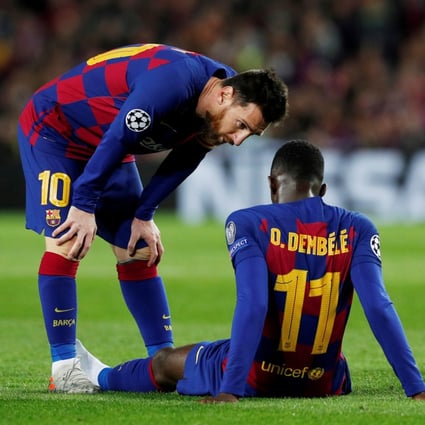 Barcelona’s Lionel Messi talks to Ousmane Dembele as he is down injured in a Champions League game against Borussia Dortmund in 2019. Photo: Reuters