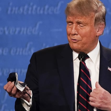 President Donald Trump holds a face mask during the first presidential debate on Tuesday in Cleveland, Ohio. Photo: AP