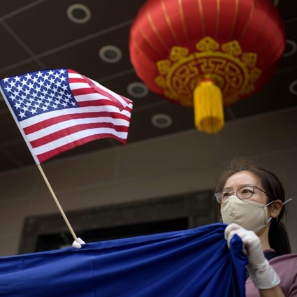 A protester holds a US flag outside the Chinese consulate in Houston on July 24, after the US State Department ordered its closure, accusing diplomats of aiding IP theft. Photo: AFP
