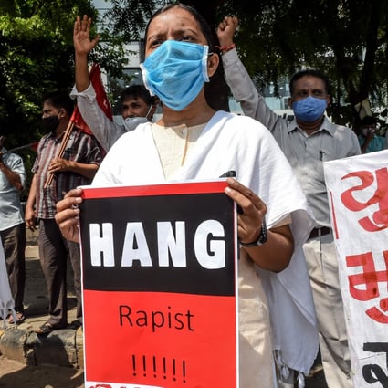 People hold placards during a protest in Ahmedabad on October 1 after the deaths of a 19-year-old and a 22-year-old woman. Photo: AFP