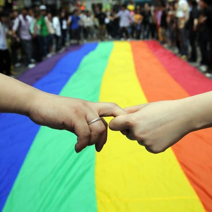 LGBT activists in Hong Kong form a human chain around a rainbow flag during celebrations marking the fourth annual International Day Against Homophobia, in May 2008. The event was launched in 2005 to commemorate the day in 1990 when the World Health Organization removed homosexuality from its list of mental disorders. Photo: AFP