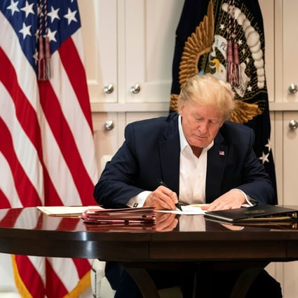 US President Donald Trump working in the presidential suite at Walter Reed National Military Medical Center in Bethesda, Maryland on Saturday, after testing positive for Covid-19. Photo: Joyce N. Boghosian/The White House via AFP