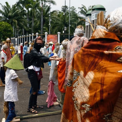 A demonstrator sets up scarecrows for keeping social distancing during a protest outside the Indonesian parliament against the Omnibus bill in Jakarta last month. Photo: Reuters