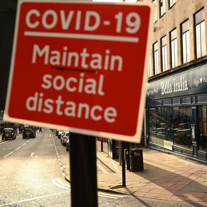 A sign near a pedestrian crossing alerts people to the need for social distancing in Liverpool, England on October 2. The UK has been designated a high-risk country by the Hong Kong government. Photo: AFP
