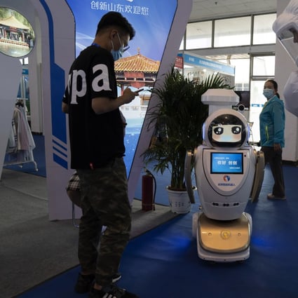 A promoter dressed to look like an astronaut walks past a robot at the China Beijing International High Tech Expo in Beijing, China on Thursday, Sept. 17, 2020. Photo: AP