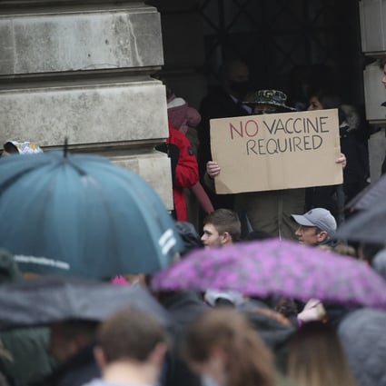 A protester holds a sign at an anti coronavirus lockdown protest in Nottingham, England, after new restrictions to combat the rise in coronavirus cases came into place in England on Saturday. Photo: PA via AP