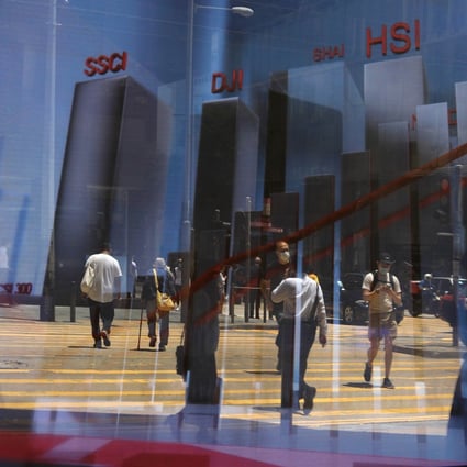 An electronic board showing the various stock market indices is seen in Central, Hong Kong. Photo: May Tse